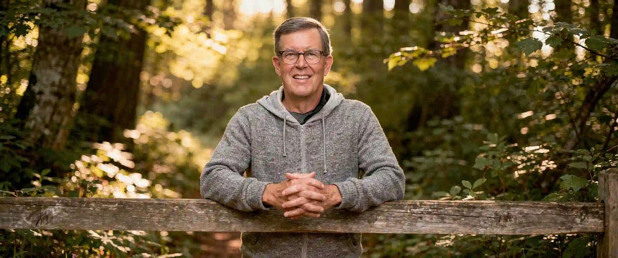 openart-sample_1780100432957_80ab7a46 copy Image of Michael Christian leaning on split rail fence in a forest at https://michaelchristian.us