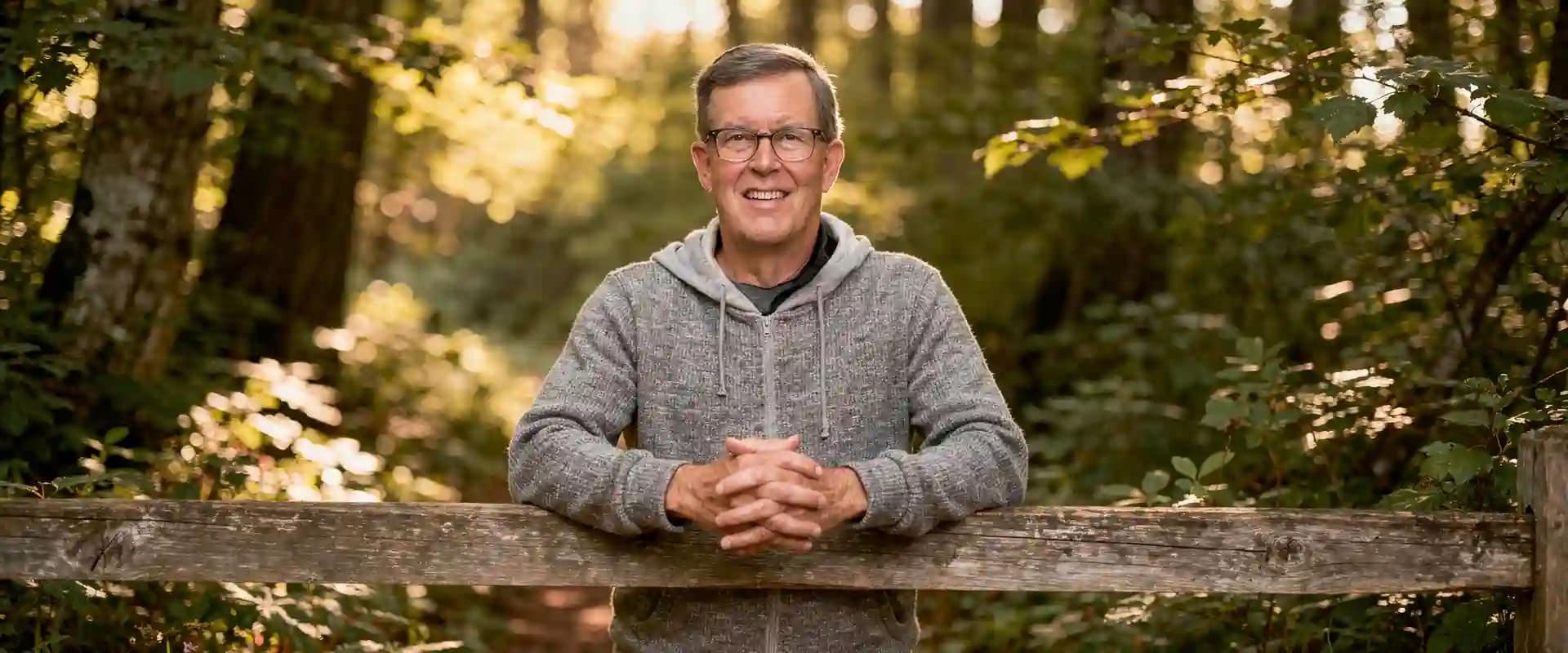 Image of Michael Christian leaning on split rail fence in a forest at https://michaelchristian.us